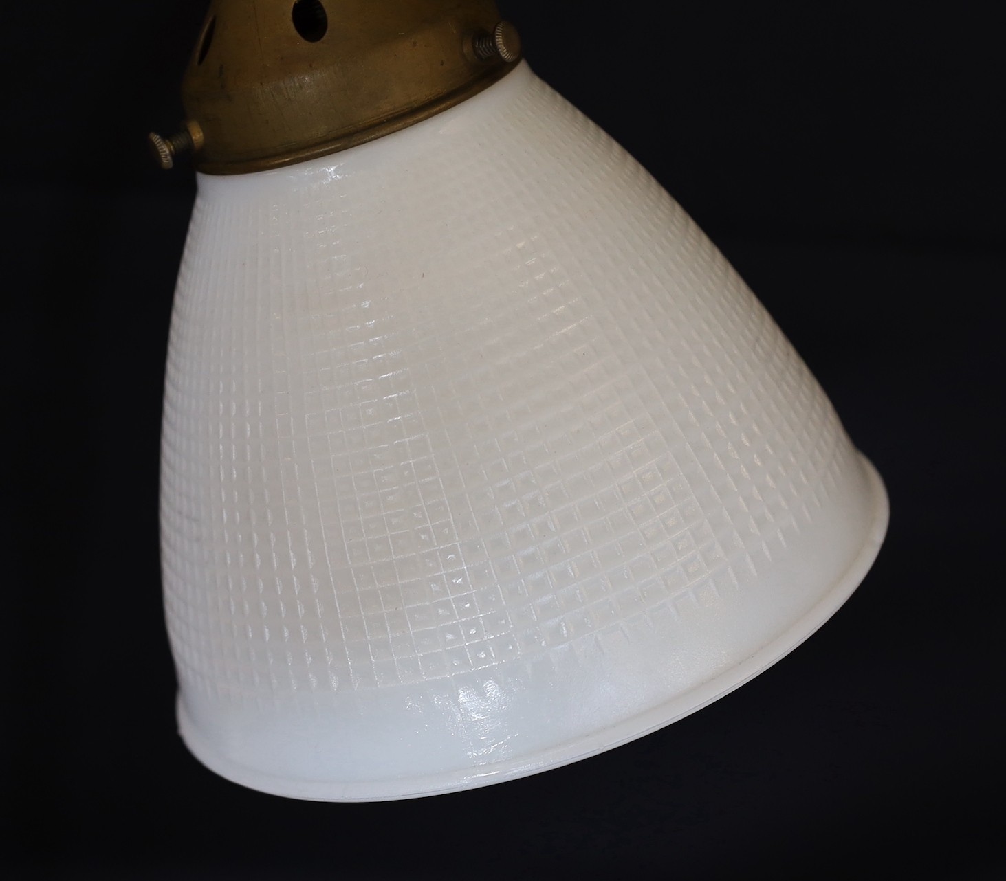 A 1930s English brass wrought iron and cast iron adjustable desk lamp with moulded opaque glass shade, height 66cm